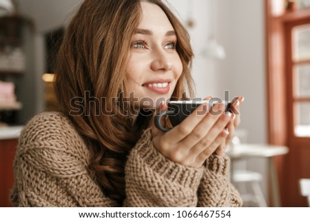 Similar – Foto Bild Eine Frau, die hinter einer halboffenen Tür Kaffee genießt.