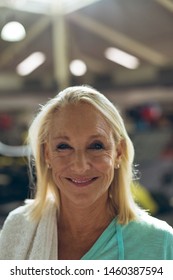 Portrait Close-up Of Happy Active Senior Caucasian Woman Looking At Camera In Fitness Studio. Strong Active Senior Female Amputee Training And Working Out