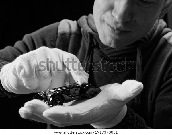 portrait of a collector of retro car models on a\
black background 2021