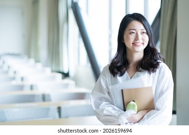 Portrait Of A College Student Standing In A Lecture Room