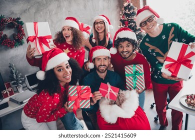 Portrait of company office workers hold presents bag santa hat new year time loft office indoors - Powered by Shutterstock