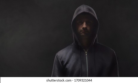 Portrait Of Computer Hacker In Hoodie. Obscured Dark Face. Data Thief, Internet Fraud, Darknet And Cyber Security .