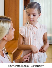 Portrait Of Concerned Woman And Child With Abdominal Pains