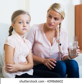 Portrait Of Concerned Woman And Child With Abdominal Pains