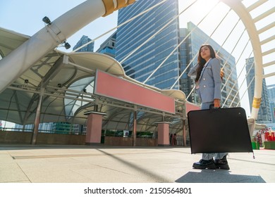 Portrait Of Confidence Asian Businesswoman Office Worker In Casual Suit Walking In Railway Station Urban City Street. Business Woman Go To Working At Office Building District In Morning Rush Hour