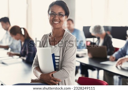 Portrait confident adult education student with books in classroom