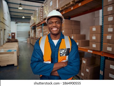 Portrait of a confident african factory engineer standing with his arm crossed in large warehouse - Powered by Shutterstock