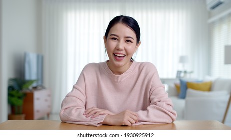 Portrait confident asia creative female vlogger make live talk video conference call, chat online on computer and sitting on table at home, Webcam view, video chat camera and Self isolation concept.