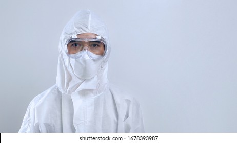 Portrait confident Asian doctor in protective PPE suit wearing face mask and eyeglasses