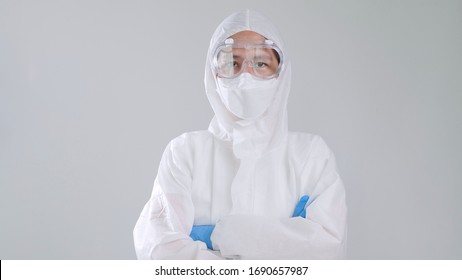 Portrait confident Asian doctor in protective PPE suit wearing face mask and eyeglasses