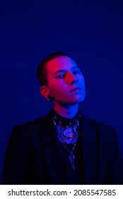 Portrait Of A Confident And Attractive Young Non Binary Person In A Red And Blue Neon Light 