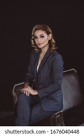 Portrait Of A Confident Beautiful Business Woman In A Suit On A Dark Background. The Concept Of Gender Equality. Strong Independent Woman. Soft Selective Focus