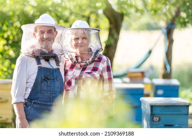 Portrait confident beekeepers in protective hats near hives - Powered by Shutterstock