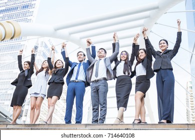 Portrait of confident business people group standing in row and with their hands holding and rise up, teamwork multicultural and togetherness concept, asian business man and woman stand in line  - Shutterstock ID 714640108