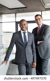 Portrait Of Confident Businessmen Standing Together In Office