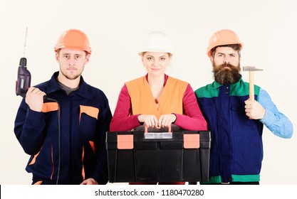 Portrait of confident carpenters carrying toolbox and tools against white background. Men and woman in hard hats ready to work.