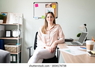 Portrait Of A Confident Caucasian Businesswoman Sitting In Her Office And Making Eye Contact