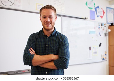 Portrait of confident Caucasian male teacher in classroom - Shutterstock ID 388588567