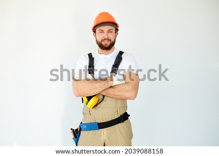 Portrait of confident caucasian mechanic with beard in overall, shirt having arms crossed, looking at camera, isolated on white background, indoors. house renovation, repair concept Foto d'archivio © 