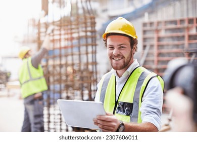 Portrait confident construction worker digital tablet at construction site - Powered by Shutterstock