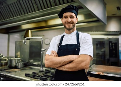 Portrait of confident cook in the kitchen in restaurant looking at camera. Copy space. - Powered by Shutterstock