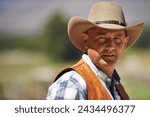 Portrait, confident cowboy and man at farm in the rural countryside for agriculture in Texas. Rancher, serious and face of male person in western hat outdoor in casual clothes in nature at stable