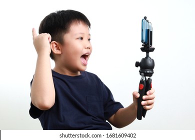 Portrait Of Confident And Creative Asian Child Blogger Talking On Camera In A Studio, He Make Video Blog. Online Influencer Vlogger Children Boy Social Media Live Streaming Concept.