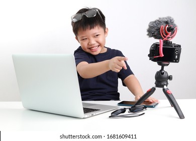 Portrait Of Confident And Creative Asian Child Blogger Talking On Camera In A Studio, He Make Video Blog. Online Influencer Vlogger Children Boy Social Media Live Steaming Concept.