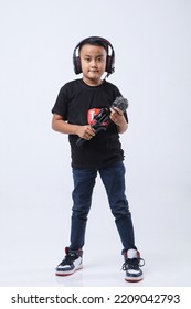 Portrait Of Confident And Creative Asian Child Blogger Talking On Camera In A Studio. Online Influencer Vlogger Children Boy Social Media Live Streaming Concept.