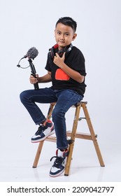 Portrait Of Confident And Creative Asian Child Blogger Talking On Camera In A Studio. Online Influencer Vlogger Children Boy Social Media Live Streaming Concept.