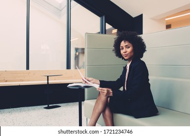 Portrait Of Confident Dark Skinned Woman In Elegant Outfit Satisfied With Successful Corporate And Finance Income Sitting In Modern Designed Office, Confident African American Director Holding Papers
