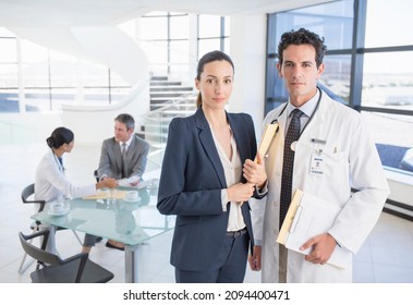 Portrait Of Confident Doctor And Businesswoman In Meeting