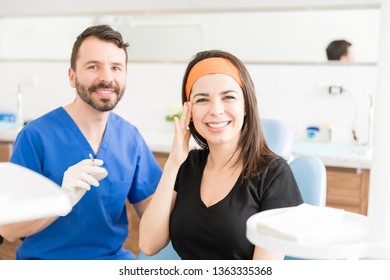 Portrait of confident doctor by smiling patient touching near her eye after getting Botox injection - Powered by Shutterstock