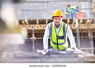 Portrait Confident Engineer With Blueprints At Construction Site