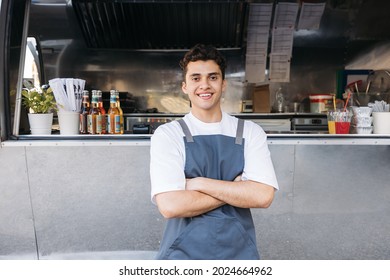 Portrait of a confident entrepreneur. Food truck owner wearing apron standing with crossed arms. - Powered by Shutterstock