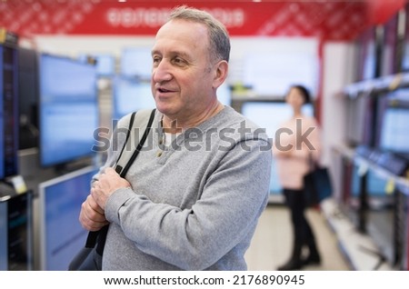Portrait of a confident European man who came to the electronics and home appliances store for a purchase in the department ..with televisions