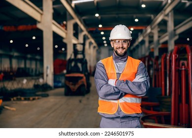 Portrait of a confident factory worker smiling at the camera and getting ready for labor. - Powered by Shutterstock