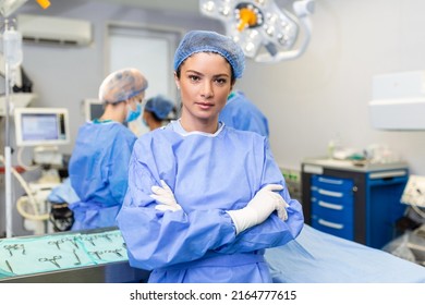 Portrait Of Confident Female Surgeon. Healthcare Worker Is Against Illuminated Lights In Hospital.