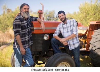 Portrait of confident friends standing near truck in olive farm - Powered by Shutterstock