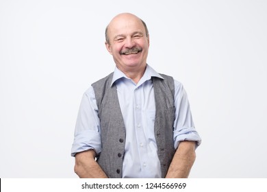 Portrait Of Confident Hispanic Mature Man Laughing And Smiling