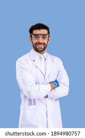 Portrait Of Confident Male Middle Eastern Arab Researcher Scientist Medical Doctor Wearing Protection Glasses Standing Cross Arms Isolated On Light Blue Background