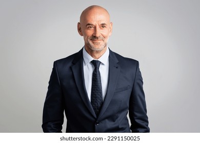 Portrait of a confident mature businessman with bald head. Senior professional man wearing suit and tie and looking at camera on white background. - Powered by Shutterstock