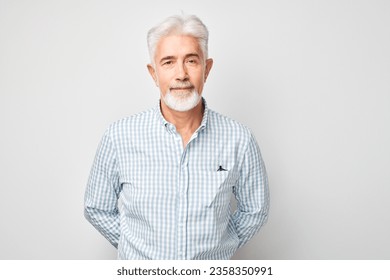 Portrait of confident mature businessman with serious face and gray hair isolated on studio background. Good looking 60 year old man, boss in business casual
 - Powered by Shutterstock