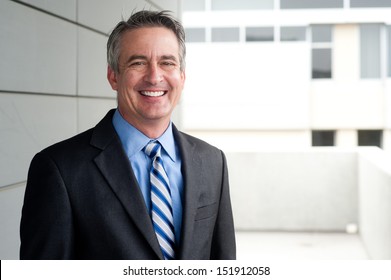 portrait of a confident mature businessman standing outside 