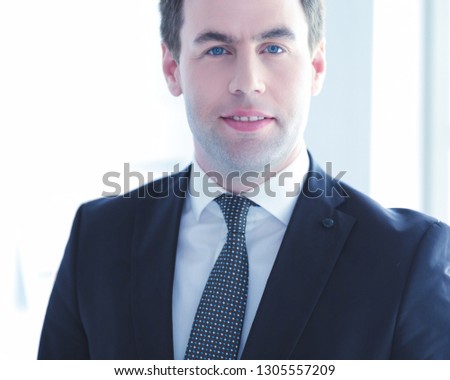 Portrait of a confident mature businessman standing outside.