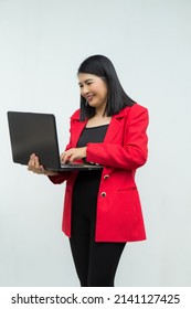 Portrait Confident Middle-aged Asian Woman Wearing Red Jacket Using A Laptop Isolated On White Background.