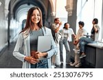 Portrait of confident motivated modern smiling female college student holding laptop and smiling. Concept of education and student life.