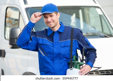 Portrait Of Confident Pest Control Worker Wearing Cap Against Truck