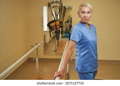 Portrait Of Confident Physiotherapist Standing In Rehab Center