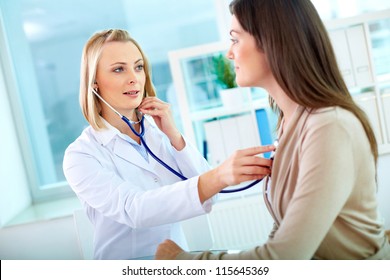 Portrait Of Confident Practitioner Checking Heart Beat Of Patient